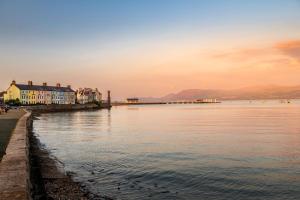 a view of a body of water with houses at Glan Y Mor in Beaumaris