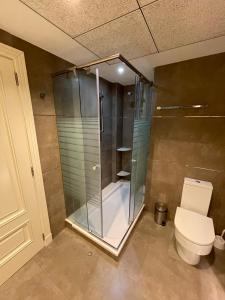 a bathroom with a glass shower and a toilet at PRIMERA LINEA PLAYA PATACONA, VALENCIA in Valencia +24 photos