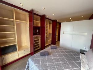 a bedroom with a bed and a large closet at PRIMERA LINEA PLAYA PATACONA, VALENCIA in Valencia