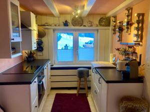 a kitchen with a large window in the middle at Ski Chalet Rinerhorn in Glaris