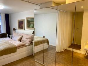 a bedroom with a bed and a glass wall at Ski Chalet Rinerhorn in Glaris