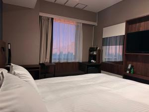 Postel nebo postele na pokoji v ubytování Hotel Odashima