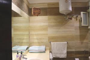 a bathroom with a sink and a toilet and a mirror at Relaxing apartment in Hurghada