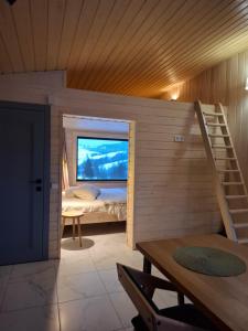 a small room with a bed and a staircase at Котедж На Лузі in Verkhne-Studënyy