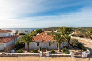 - Vistas a una casa con palmeras en Villa Las Terrazas - Es Canutells, en Es Canutells