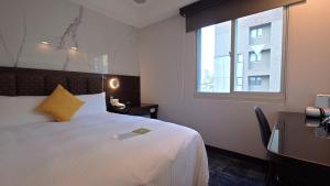 Rúm í herbergi á Hub Hotel - Zhongshan Branch