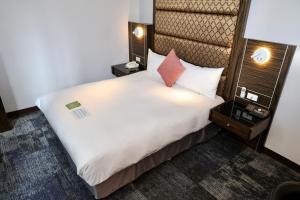 Rúm í herbergi á Hub Hotel - Zhongshan Branch