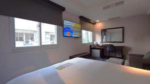 Rúm í herbergi á Hub Hotel - Zhongshan Branch