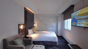 Rúm í herbergi á Hub Hotel - Zhongshan Branch