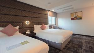 Rúm í herbergi á Hub Hotel - Zhongshan Branch