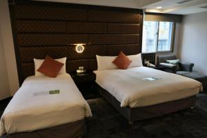 Rúm í herbergi á Hub Hotel - Zhongshan Branch