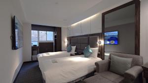 Rúm í herbergi á Hub Hotel - Zhongshan Branch