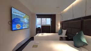 Rúm í herbergi á Hub Hotel - Zhongshan Branch