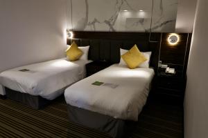 Rúm í herbergi á Hub Hotel - Zhongshan Branch