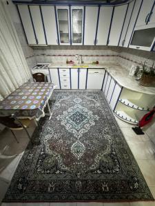 a kitchen with a rug on the floor and a sink at Kesen Cappadocia House in Ürgüp