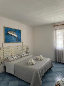 a bedroom with a large bed with towels on it at B&B Una favola di mare in Lampedusa