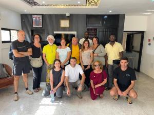 a group of people posing for a picture in a room at Airport INN Hotel in Lomé