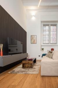 a living room with a couch and a flat screen tv at Mgm Property - Wonderful Loft Tartaglia in Milan
