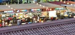 a crowd of people sitting at tables in a market at Hotel Twelve at 12 Kuantan Centre in Kuantan