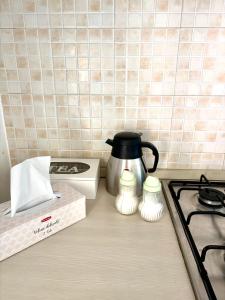 a kitchen counter with a tea kettle and a stove at Alloggio Zara in Biella +7 photos