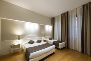 Postel nebo postele na pokoji v ubytování Hotel Cosimo de' Medici