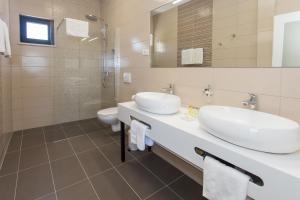 a bathroom with two sinks and a toilet at Villa Lemon Tree in Vinišće