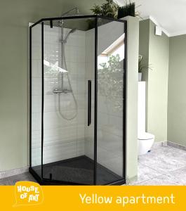 a shower with a glass door with a yellow appointment at House of Art in Łomianki +35 photos