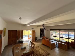 a dining room and living room with a table and chairs at Trout Lodges Naran in Naran