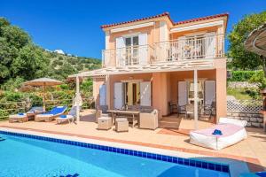 a villa with a swimming pool and a house at Villa Zeus Skala by Villa Plus in Mavráta