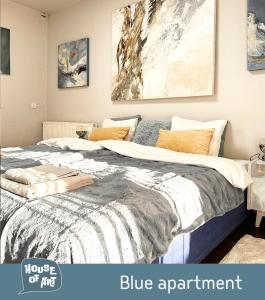 a bedroom with a large bed with a blue apartment at House of Art in Łomianki