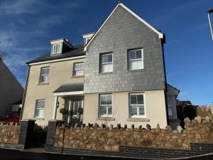 a house with a fence in front of it at Tobystar house in Plymouth