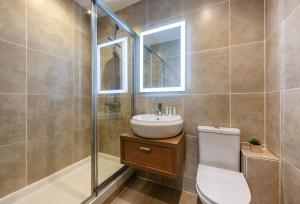 a bathroom with a toilet and a sink and a shower at The View in Carbis Bay