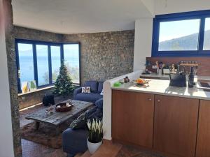 a kitchen and living room with a couch and a table at Seabreeze in Xeronísi