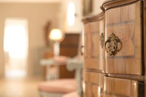 a room with a wooden cabinet with a horse head on it at Château du Tertre in Arsac