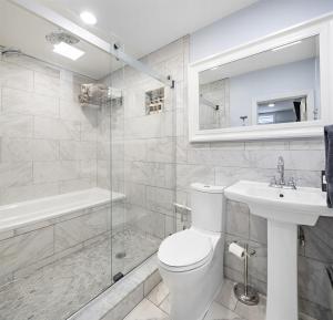 a bathroom with a toilet and a sink and a shower at Cozy Apartment with Max Comfort in Bayonne +18 photos