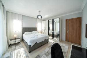 a bedroom with a large bed and a large mirror at Villa Türkoğlu Akyaka Kuyucak Daily Weekly Rentals in Mugla +46 photos