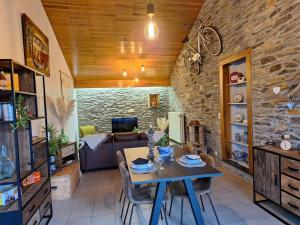 a living room with a table and a couch at Gite Le Grenier in Lierneux