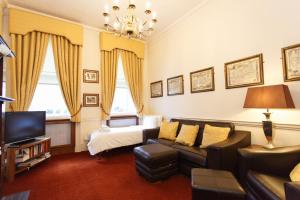 a living room with a couch and a bed at Morgan Hotel in London