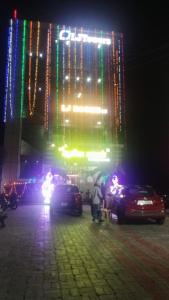 a building with a lit up sign at night at LJ Rooms in Pākkam