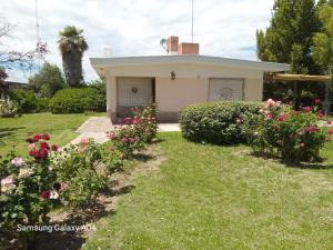 ein kleines weißes Haus mit Blumen im Hof in der Unterkunft Damasco in San Rafael + 1 Foto