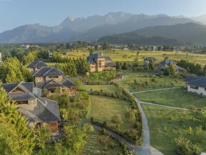 an aerial view of a home with mountains in the background at Echor Hill Farm Cottages Palampur in Pālampur +45 photos
