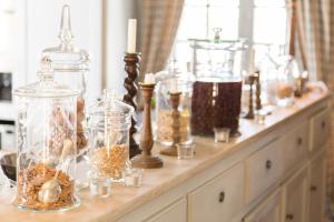 a table with many glass jars and candles on it at Château du Tertre in Arsac