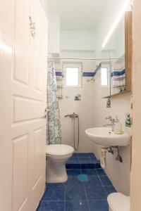 a bathroom with a toilet and a sink at George Central Apartment in Pýrgos +20 photos