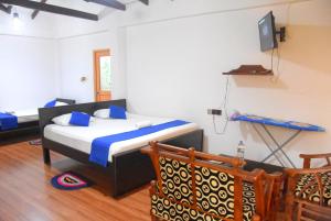 Letto o letti in una camera di Tunnel Side Hotel Ramboda