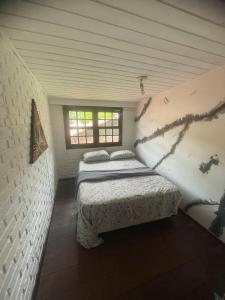 two beds in a small room with a window at O Maior hostel da Lagoa in Florianópolis +13 photos