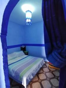 a blue room with a bed with a blue ceiling at Casa Terassa in Chefchaouene