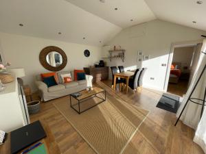 a living room with a couch and a table at The Grange Silverstone in Towcester