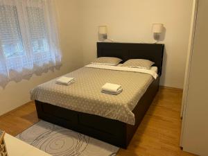 a bedroom with a bed with two towels on it at Apartman Mila - free parking and WiFi in Rijeka