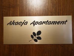 a sign on a door with aagzona agreement on it at Akacja Apartament in Rzeszów