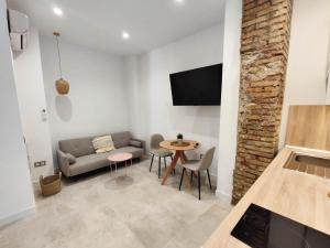 a living room with a couch and a table at La estación in Málaga